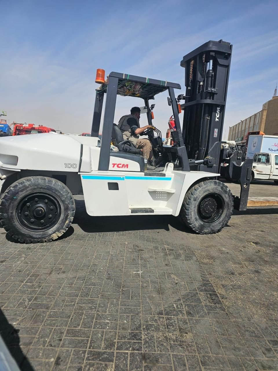 Forklift operator driving on a city street