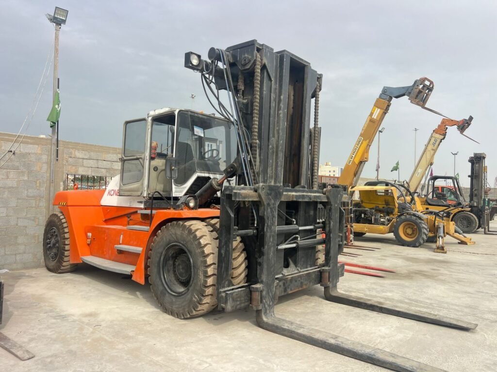 Heavy-duty forklift parked in an equipment yard with a telehandler nearby