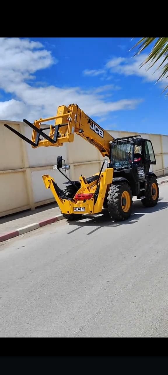 Telehandler with fork attachment on a city street
